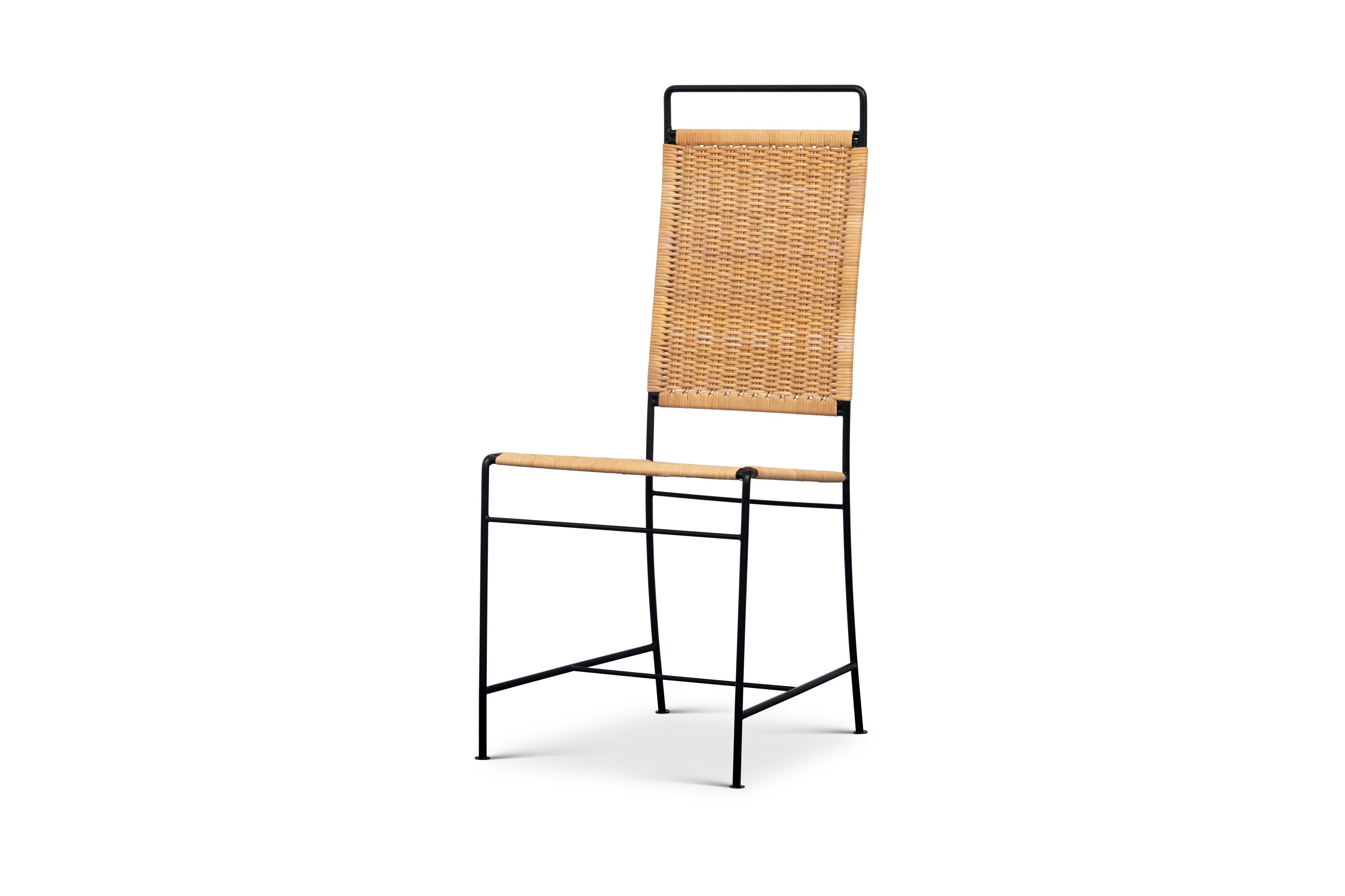 The Dodi chair has a blackened steel frame with a handwoven back and seat of natural rush. Cross stretchers offer stability and the legs are finished with coin-shaped tabs.

The chair frame is also available in stainless steel.

This Dodi chair