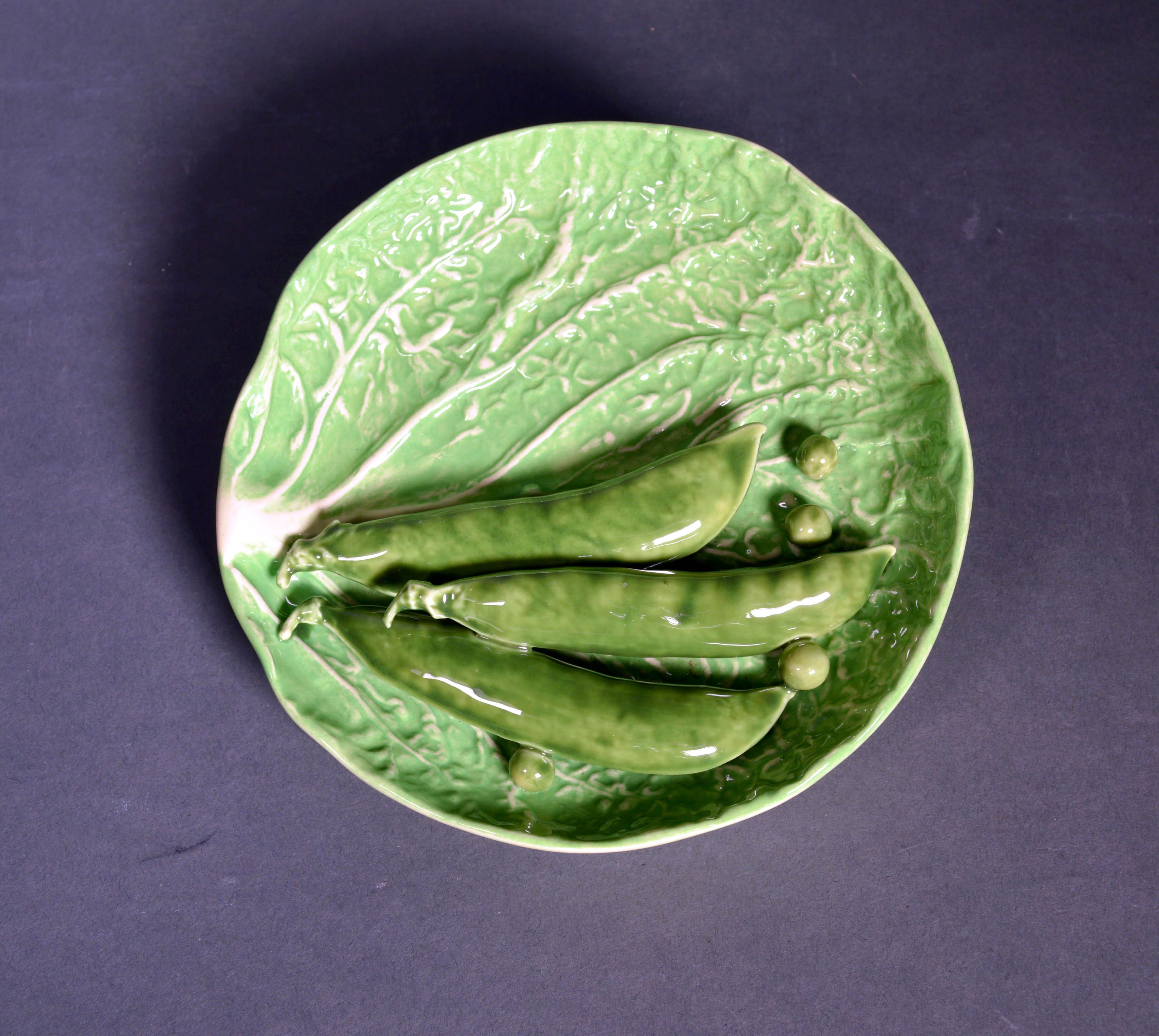 Dodie Thayer lettuce ware peapod dishes,
Set of four,
1970-1980s
  

Each charming Trompe L'oeil circular small dish is in the form of a lettuce leaf with a grouping of three peapods and several loose peas applied to the surface.

Dimensions: