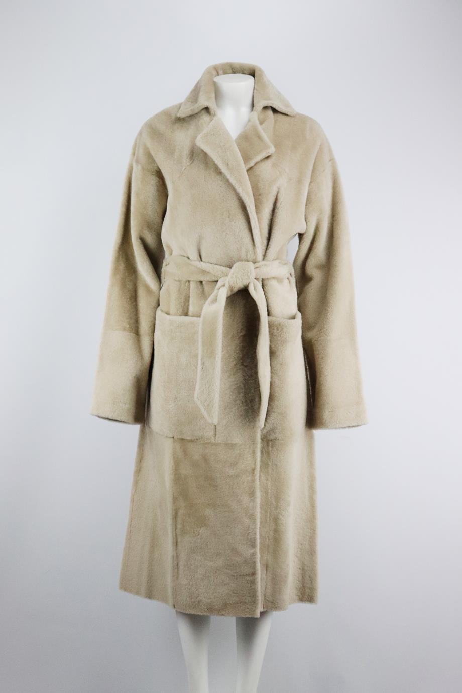 Dodo Bar Or belted shearling coat. Cream. Long sleeve, v-neck. Belt fastening at front. 100% Leather. Size: IT 40 (UK 8, US 4, FR 36). Shoulder to shoulder: 18 in. Bust: 43.2 in. Waist: 44 in. Hips: 49 in. Length: 50.4 in New with tags
