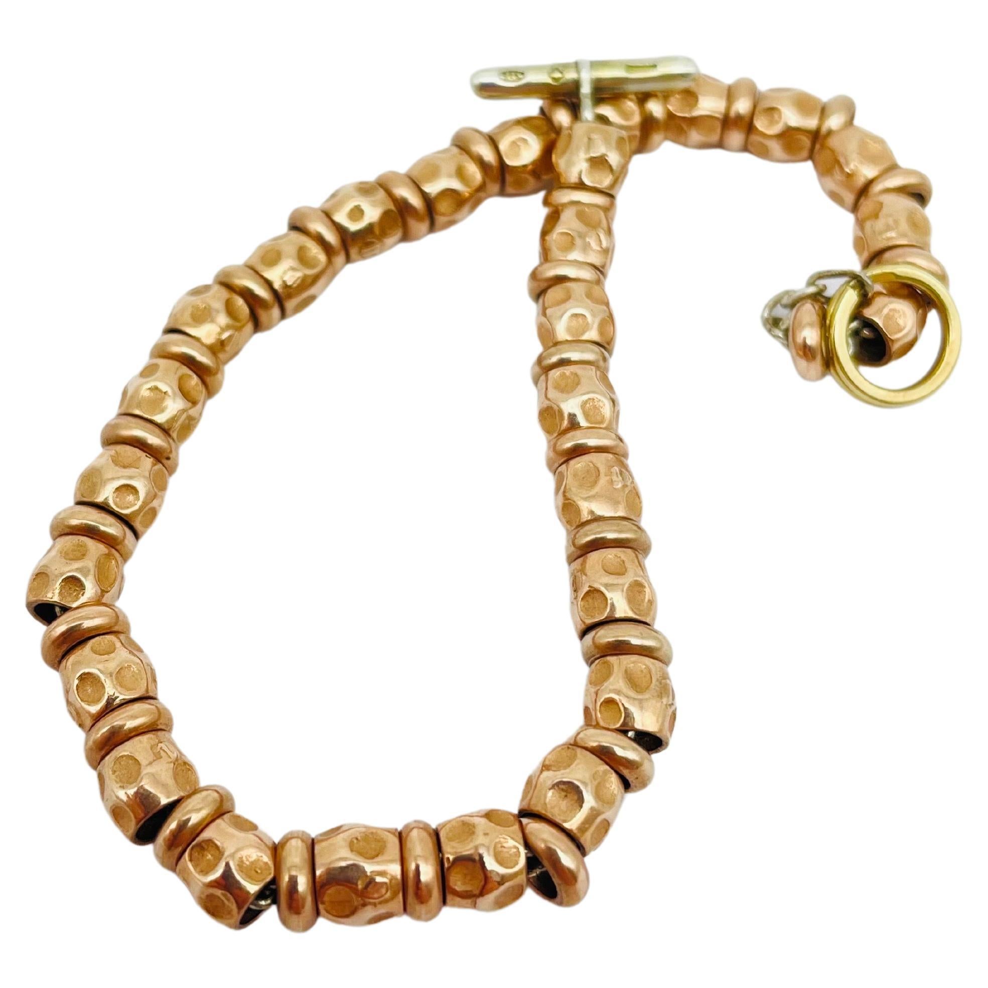 Introducing the luxurious and stylish DODO by Pomellato Granelli bracelet, crafted to perfection from 18k rose gold plating on 925 silver, complemented by the exquisite 18k yellow gold Brisè. This exceptional piece features a design that is both