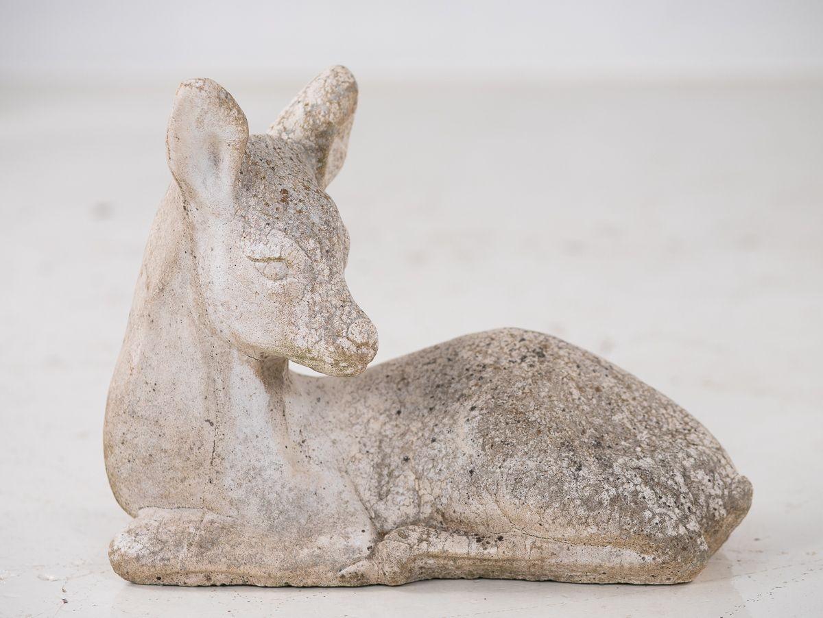 A mid 20th century French cast stone doe or deer garden ornament. This garden ornament retains much of its original white finish. Wear consistent with age and use.