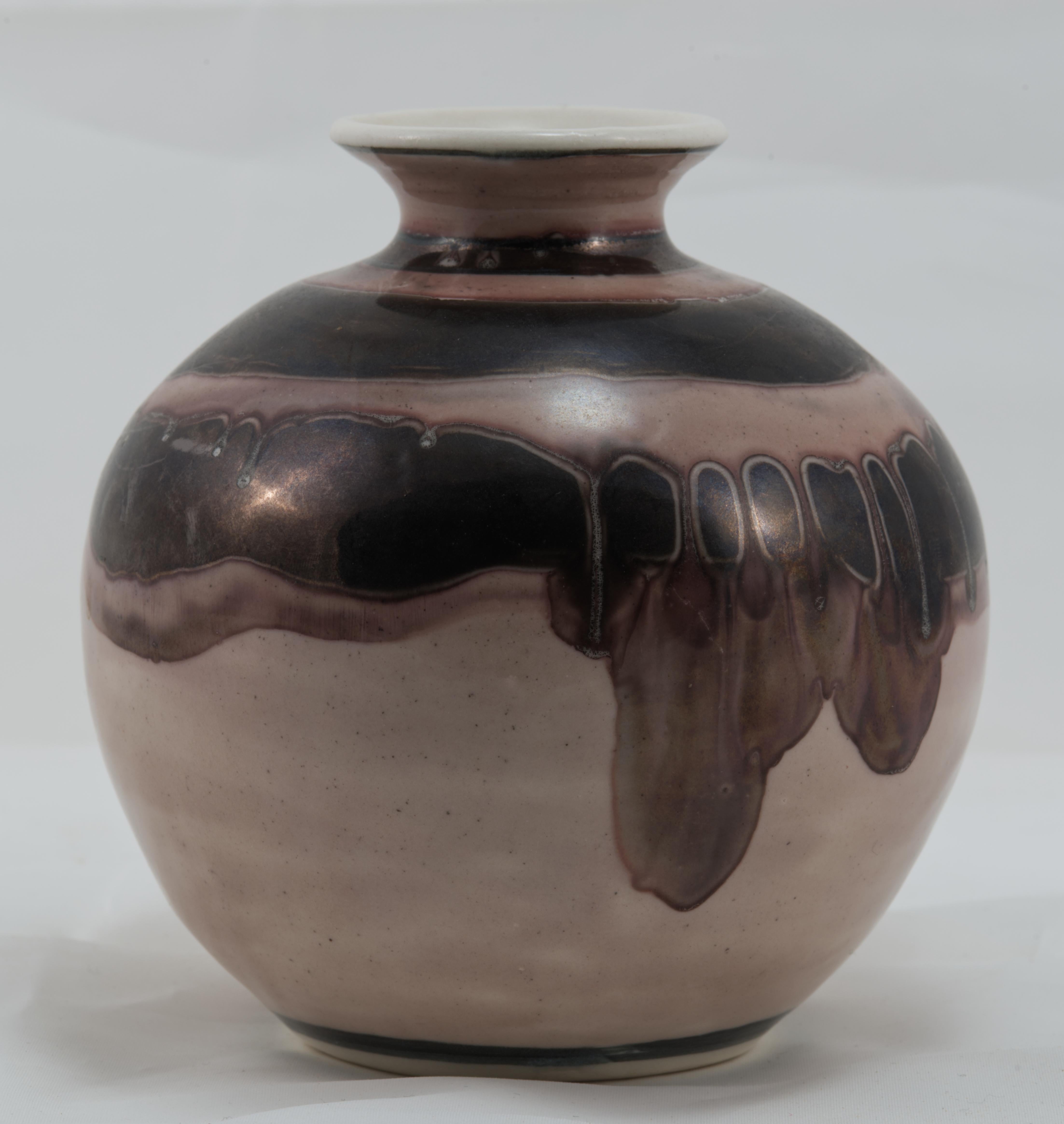 Striking vintage art pottery bud vase features Organic Modern decor in pink, plum, and brown glaze on soft pale pink background. The porcelain or ceramic vase is hand-sculpted in coil technique with characteristic delicate texture, noticeable by