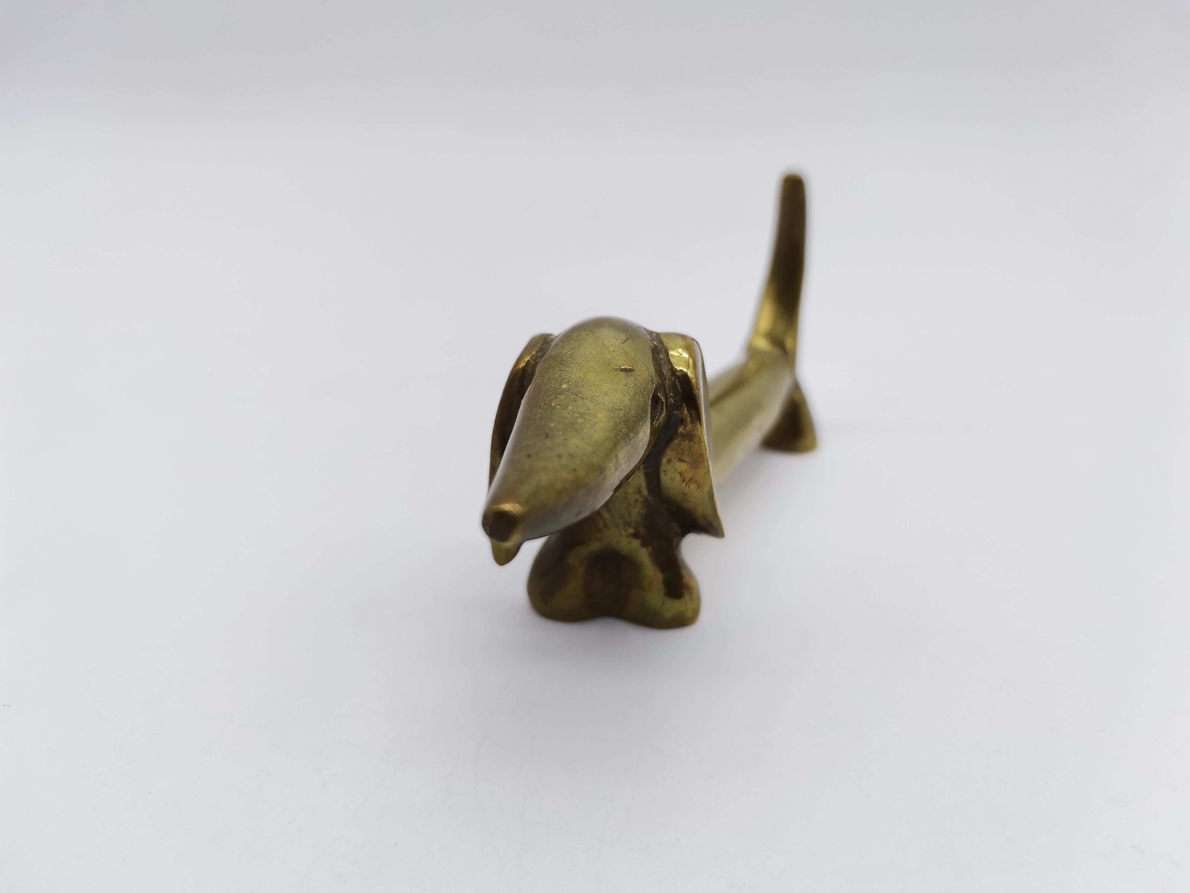 A small dog figurine by Walter Bosse made of brass.