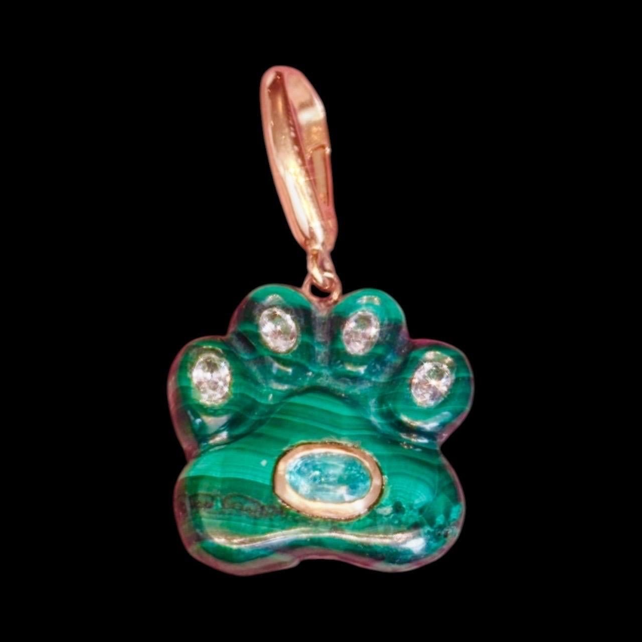 Dog Paw Pendant

Malachite, Diamonds, Emerald & 14k Gold

Hand carved malachite dog paw with four oval diamonds - one in each paw and an oval emerald bezeled in 14k gold in the dog pad.

The pendants measure 3/4” in diameter. The 14k gold bail