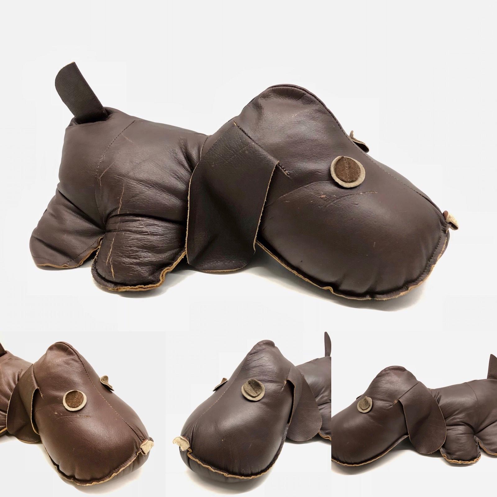 Dark brown leather handmade pouf or decoration animal in the form of a dog. This leather animal with a nice patina, gives your living room a beautiful style. It has some scratches in the leather, but this is old-age.