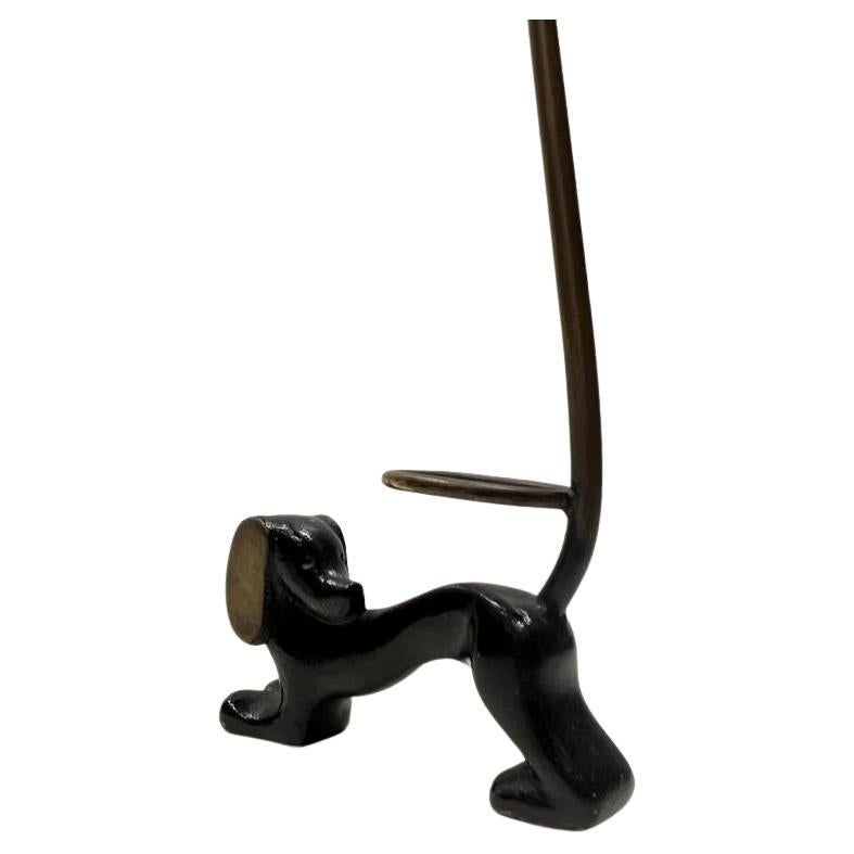 A blackened brass ring holder in shape of a dog.