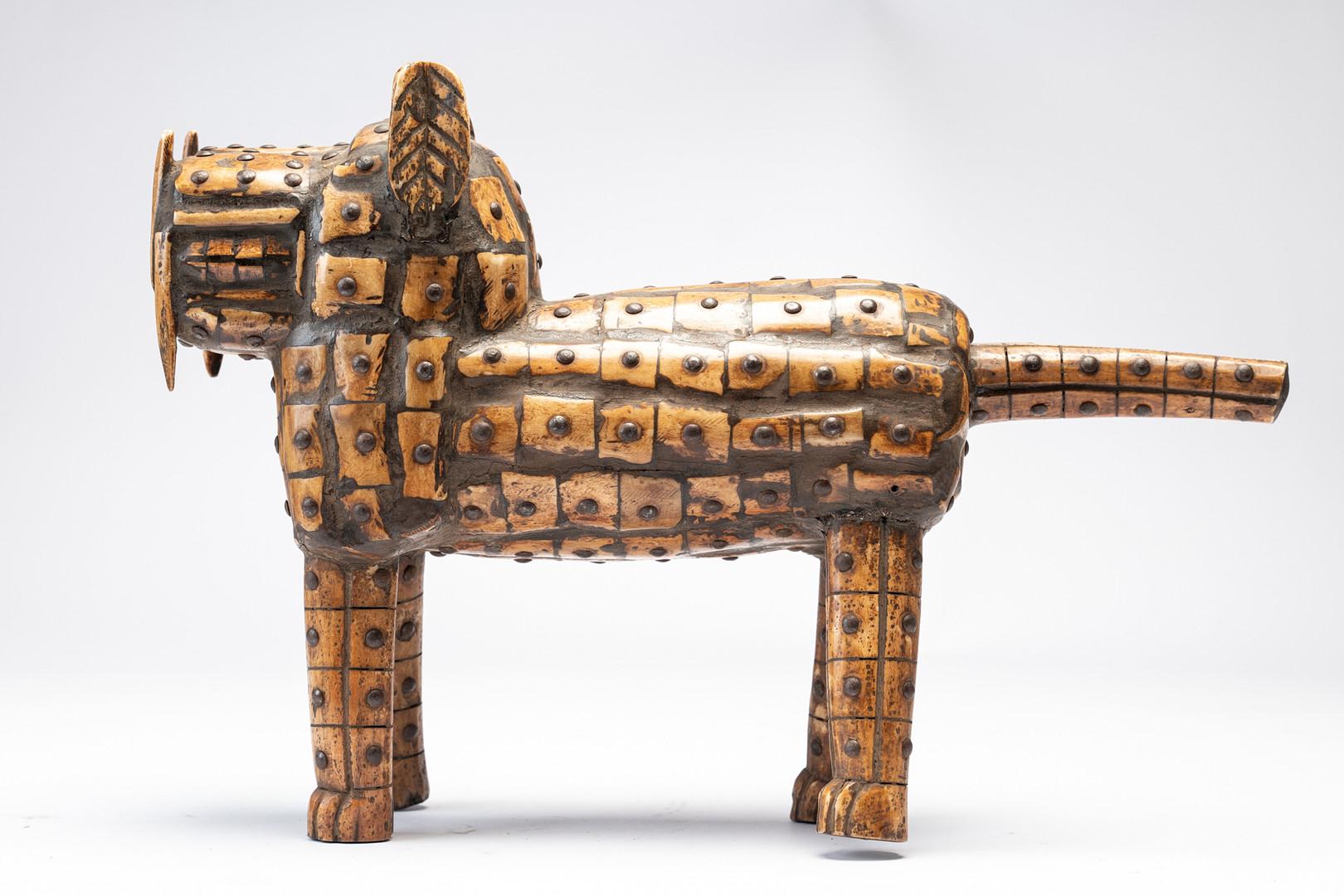 A stand-out piece from the former Benin state, well known for its high level artistic traditions. This Dog Sculpture is made of a wooden base, with riveted pieces of ivory attached with nails. Elegant and refined craftsmanship, yet very modernistic