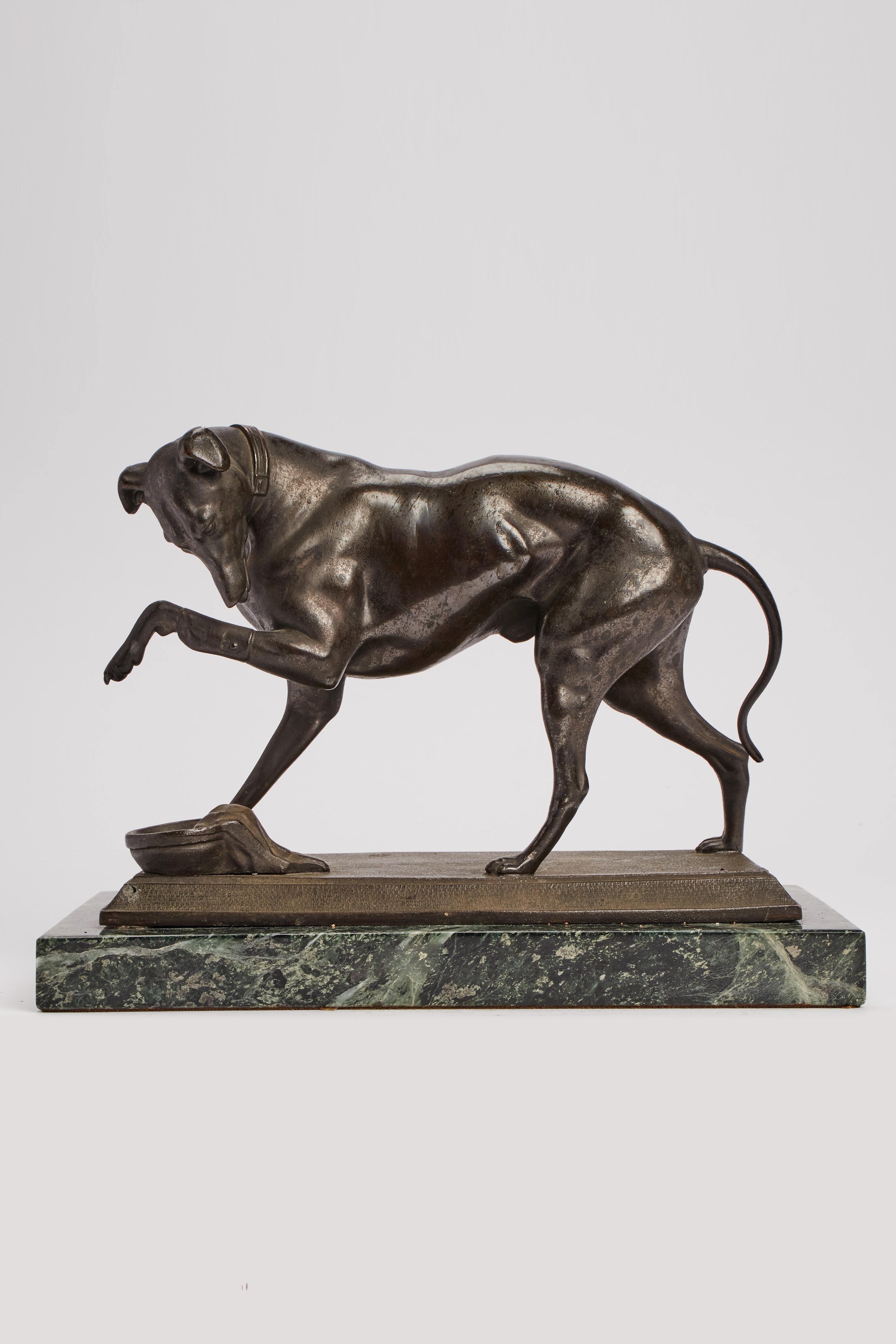 Sculpture of a stand grayhound that licks his wound. Patinated antimony over green marble base. France circa 1890.