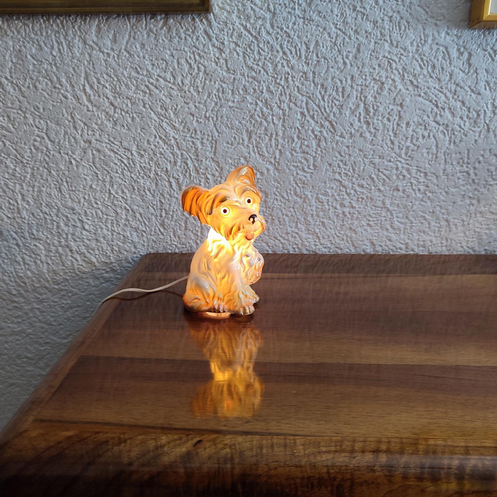 Rare find, a dog perfume lamp attributed to Carl Scheidig Grafenthal, Germany. 
Porcelain figurine, with luster glaze. E14 bulb base. European plug. It can be usd in the US with proper light bulb and with a plug adapter.
Excellent condition, lamp is