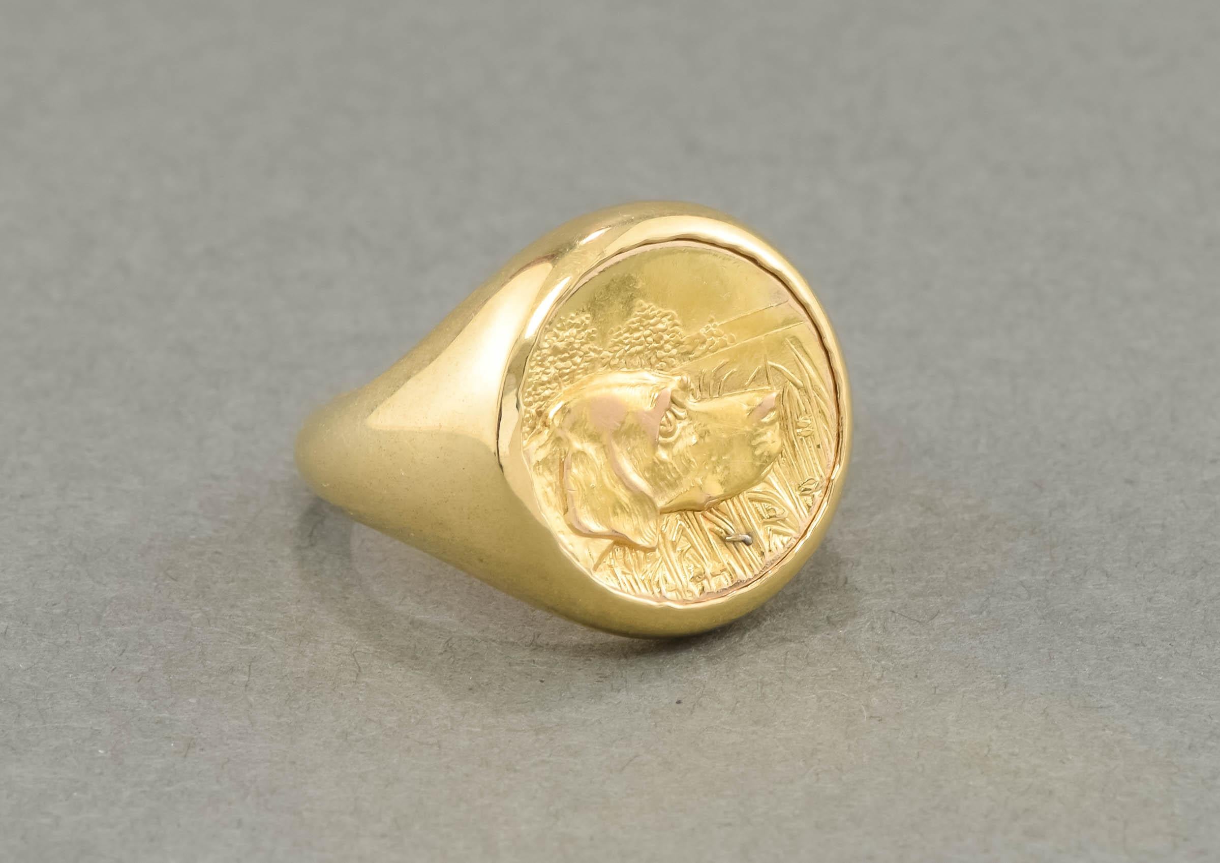 A lovely, one of a kind signet ring for a man or a woman, this beauty is both a substantial and elegant statement piece for the dog lover.  

Featuring an original Art Nouveau period plaque of a Retriever or Hound dog, the ring is 14K yellow gold,