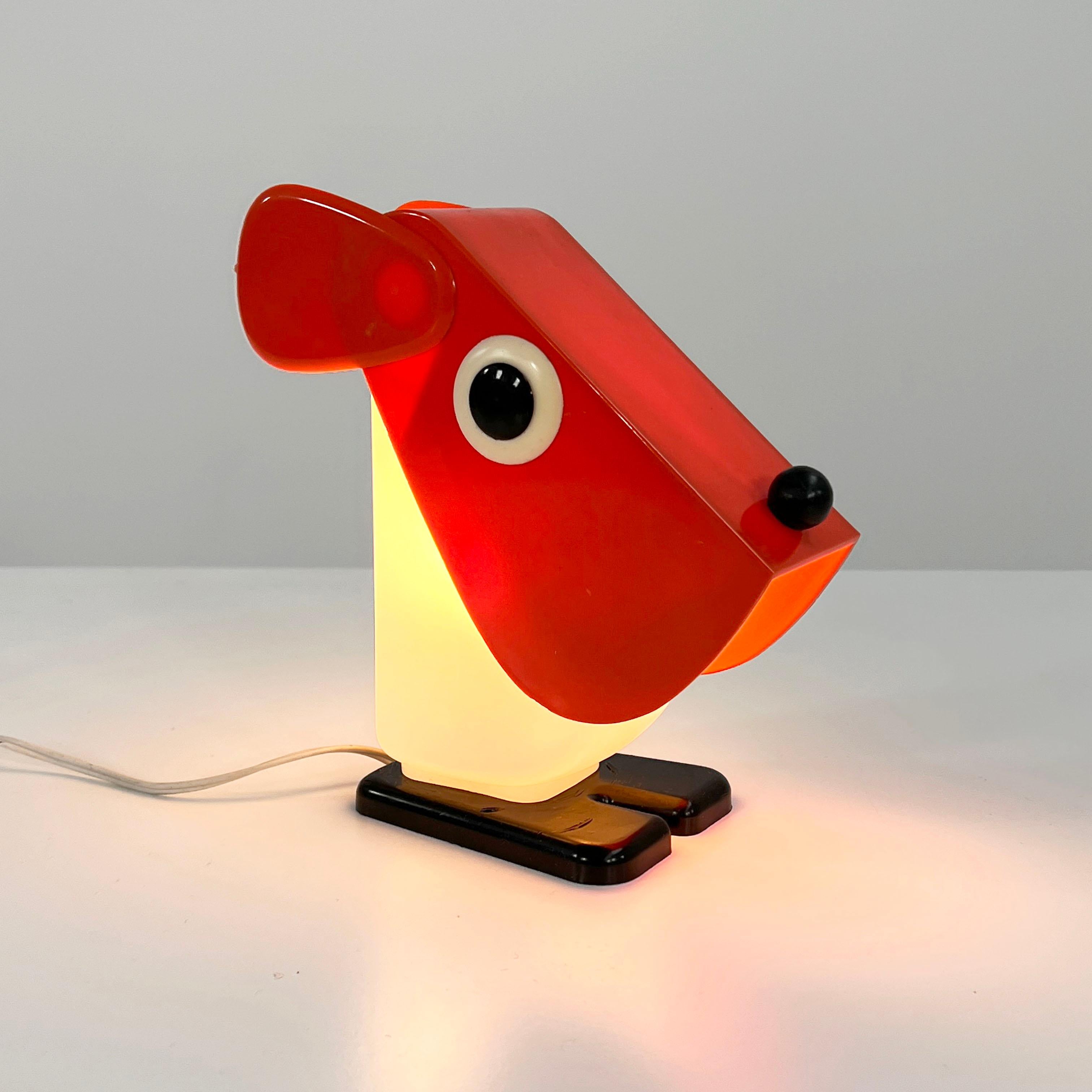 Designer - Fernando Cassetta 
Producer - Tacman
Model - Dog Table Lamp 
Design Period - Seventies
Measurements - Width 8 cm x Depth 18 cm x Height 20 cm
Materials - Plastic, Glass
Color - White, Red, Black
Light wear consistent with age and