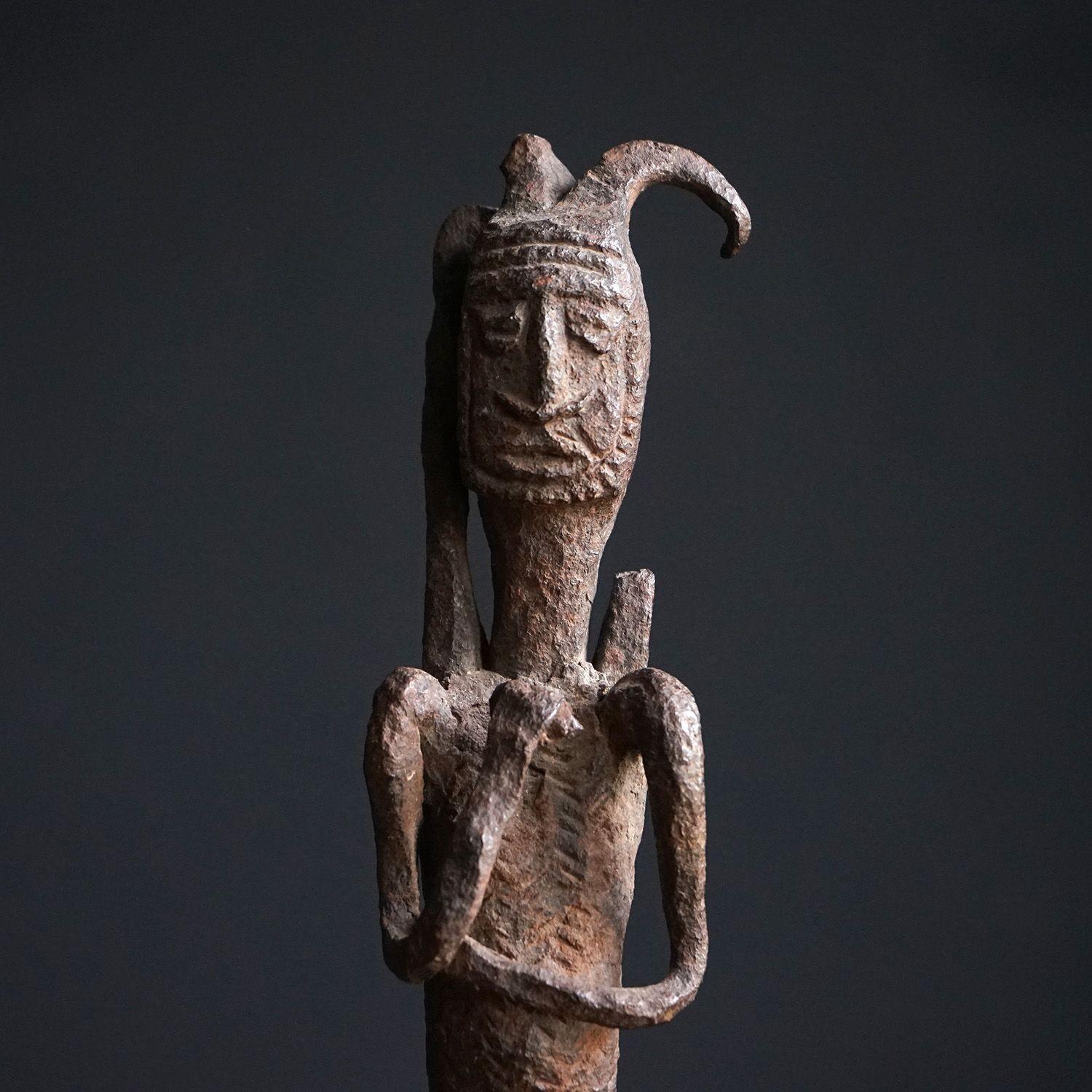 WEST AFRICAN FIGURE
Depicting a male figure with wonderful character, possibly relating to fertility and masculinity due to his genitalia.
 
It would have originally been the top of a long iron staff.
 
On complimentary neutral metal stand.
