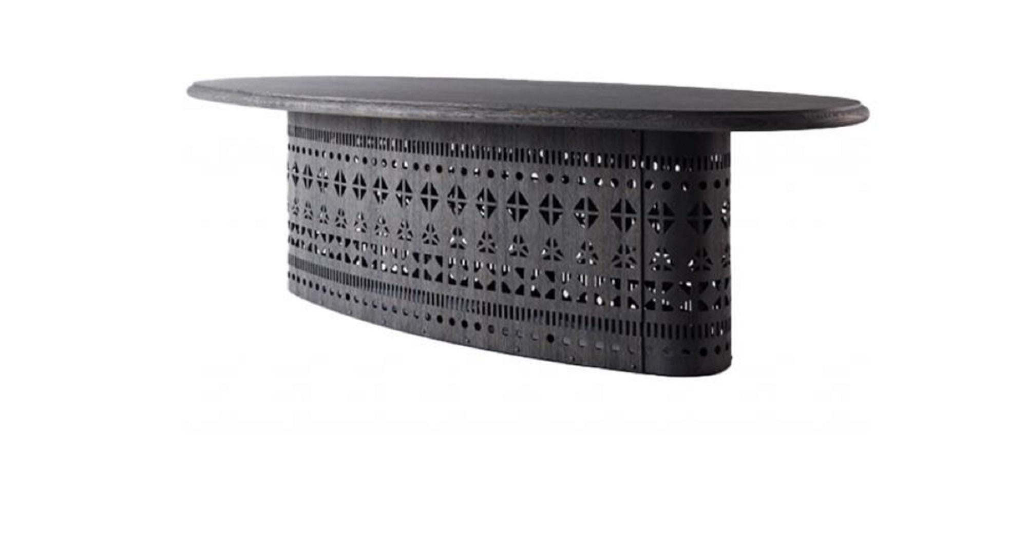Dogon T Table 
Designer: Ferruccio Laviani

Brand: Emmemobili

Design Concept: A refined blend of modern form, artisanal detail, and ethnic inspiration.

Construction & Materials
Shapes: Available in round or oval versions.

Base:

Made from a
