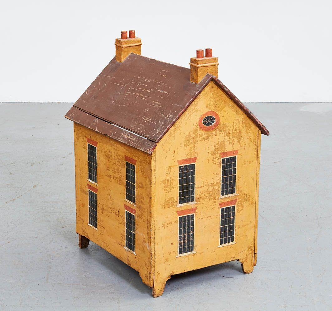 A 19th c. English doghouse for a small dog in the form of a Georgian townhouse in lovely original faded ochre paint with a pitched gable roof with two chimneys with double chimney pots. Great painted detail including 12 over 12 double hung sash