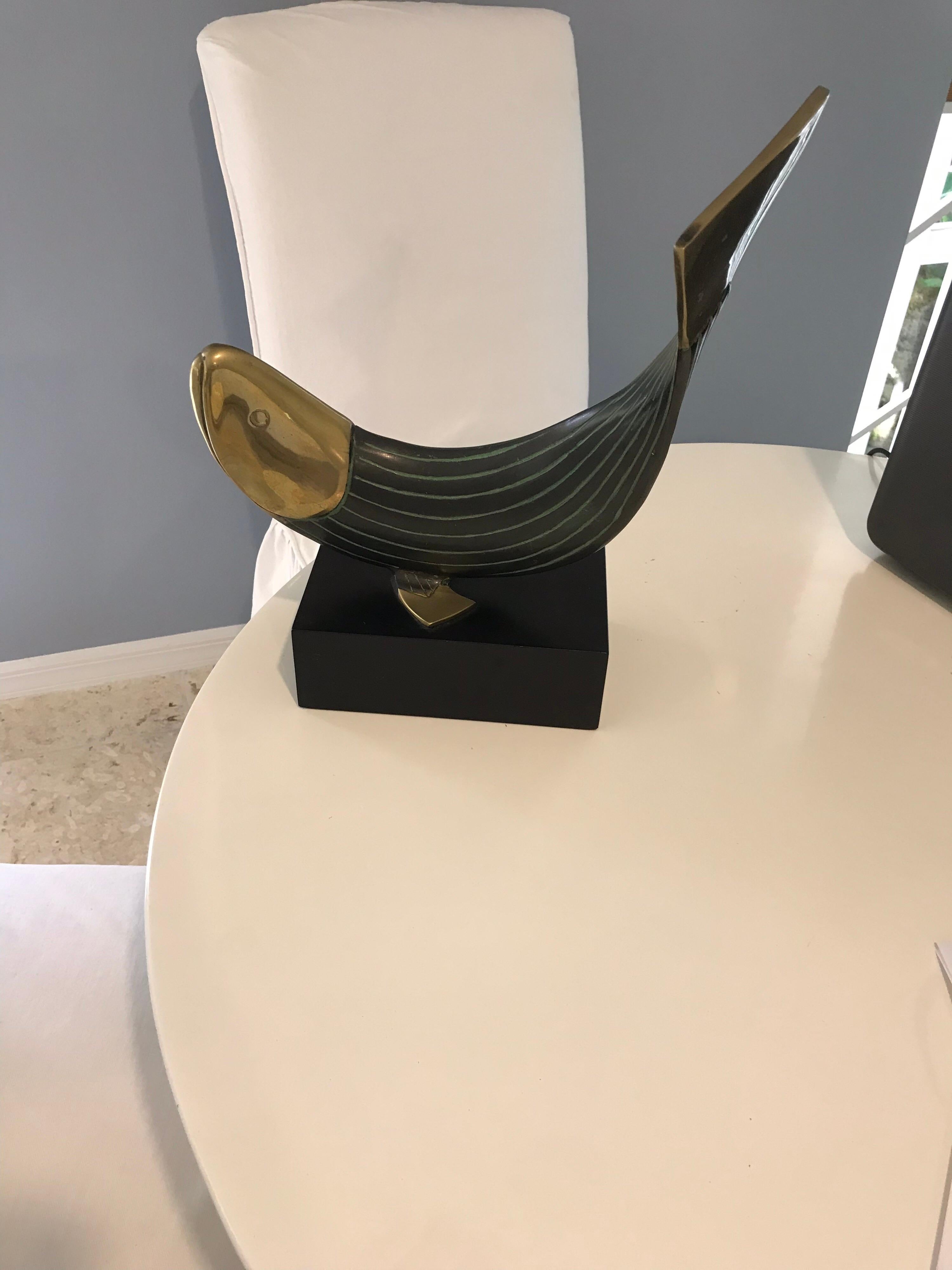 This is a modern brass and metal fish statue mounted on a metal Stand made by Dolbi Cashier in 1990.