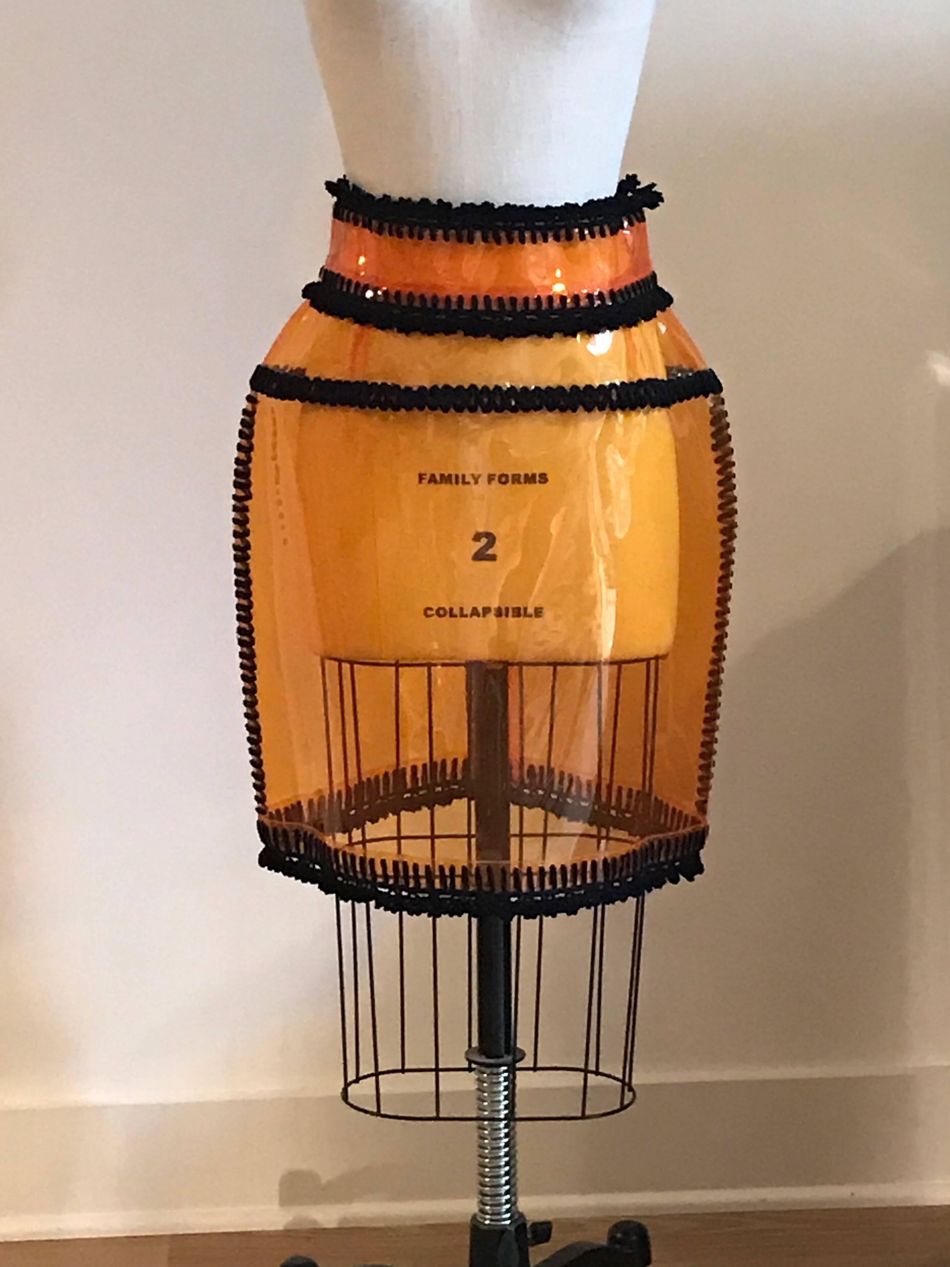 Dolce & Gabbana orange PVC skirt with black trim. High waisted, back zip. As seen on the Spring 2012 runway in look 49.

(Note, any printing is that showing through from our dress form, there is no text on the skirt.)

100% PVC with yarn like