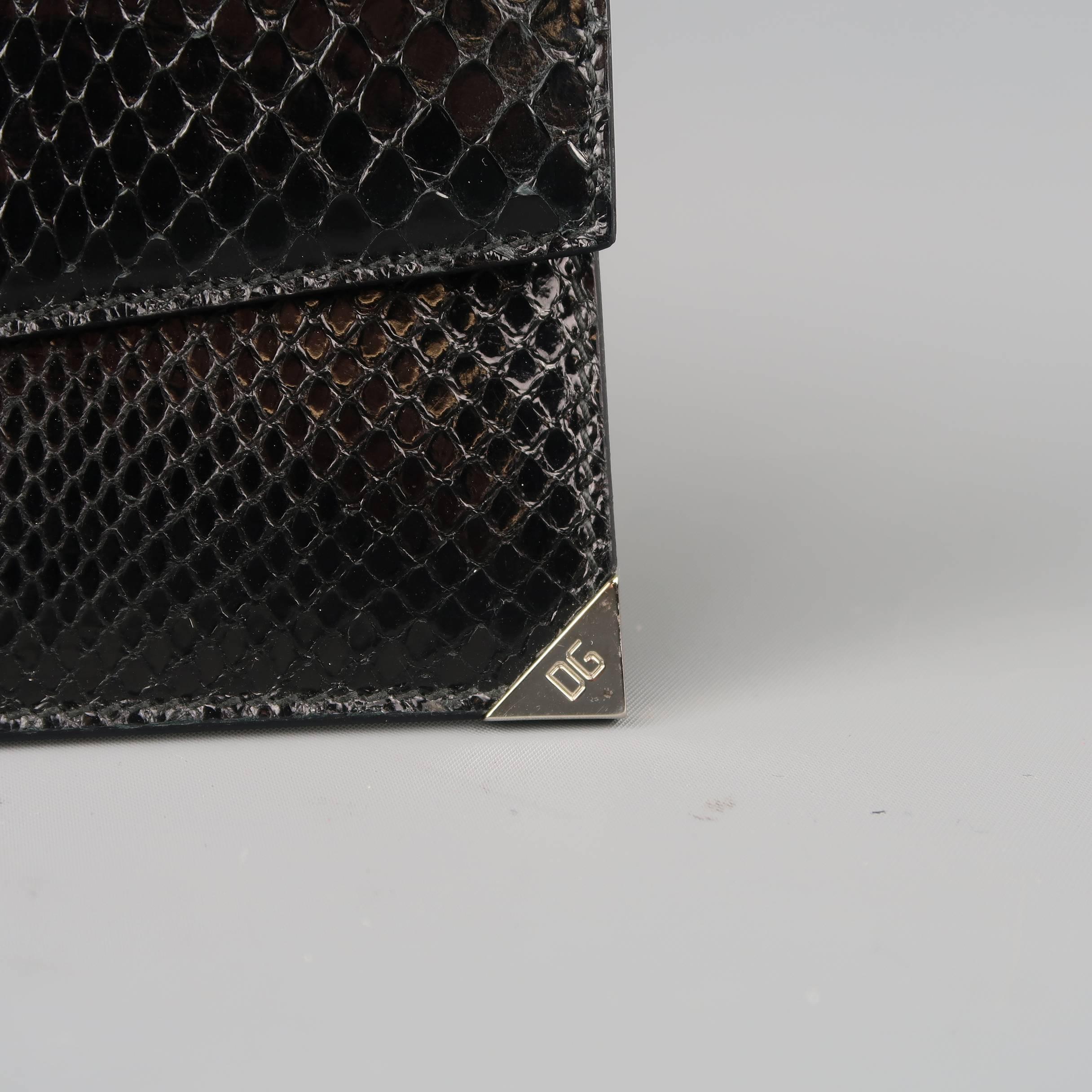 DOLCE & GABBANA wallet comes in black snakeskin leather and features an envelope holder with snap closure and silver tone embossed corner with internal card holder. Made in Italy.
 
New with Tags.
 
5.5 x 3.25 in.
