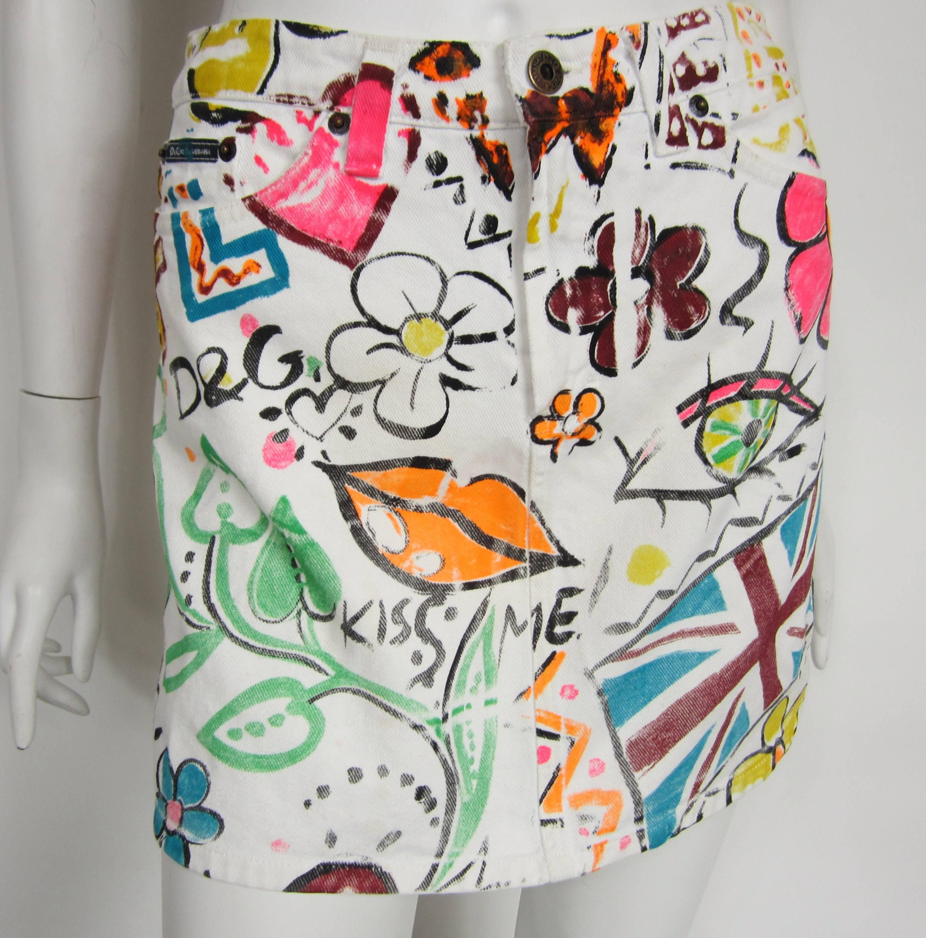 Spring has sprung with this Dolce & Gabbana White Denim Skirt. Fabulous Graffiti print. Labeled 26/40 - 28 inch waist --34 hips -- 14.5 inches long. Please check our storefront for more contemporary, vintage, hundreds of pieces of designer and fine