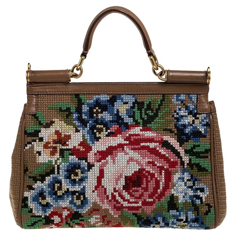 This gorgeous Miss Sicily bag from Dolce & Gabbana is a handbag coveted by women around the world. It has a well-structured design and a flap that opens to a compartment with satin lining and enough space to fit your essentials. It features a