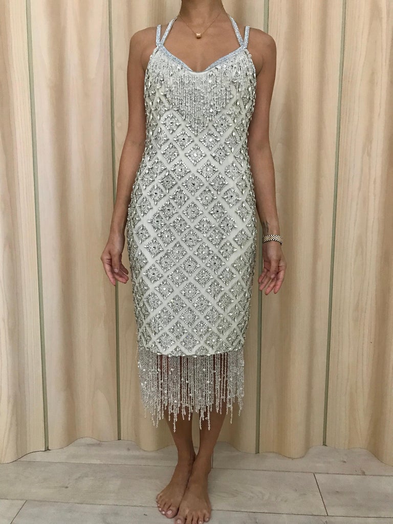 Rare 2004 Dolce and Gabbana White Spaghetti Strap Beaded Rhinestones Dress with tassel beads. Flapper Dress.
Dress is heavy. 
Fit best for size 0/2 US size. ( model measurement: 32 inches/ 24 inches/32 hip