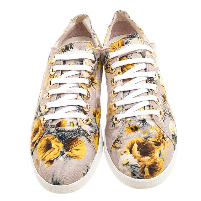 You can look bright as the sun by wearing these low styled sneakers from Dolce and Gabbana. It is made from canvas and has a fine print of flowers all over. This laced up pair of shoes has the metal eyelets and strip on the lower back quarter is
