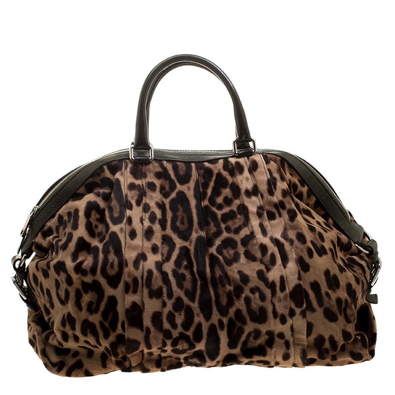 This stunning satchel is by Dolce&Gabbana. Crafted from calf hair, the bag features leopard-prints all over, two handles and a spacious fabric interior. Swing it along while you travel to lend your outfit the appropriate measure of class and
