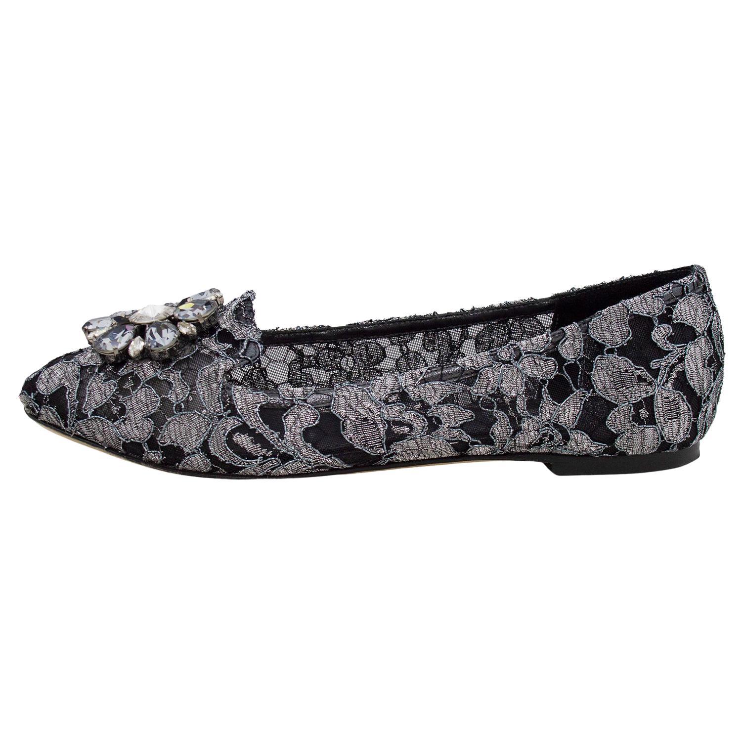 Dolce and Gabbana house-signature black and silver Taormina lace Vally ballerina flats. Slipper shape with round toe featuring a flower shaped crystal embellished appliqué. Fabric lining with leather sole and insole. Handmade in Italy. Excellent