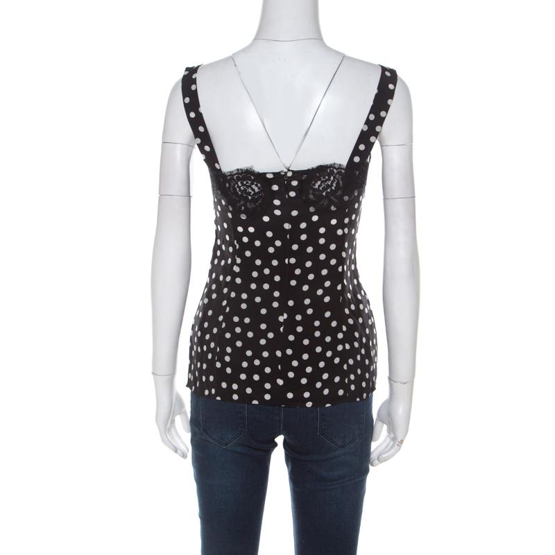 Dolce and Gabbana's camisole is a pretty collision of style, beautiful detailing, and fitted silhouette. The polka dot-printed top features lace inserts that exude flattering, feminine charm. Completed with thin straps, wear this with loose pants