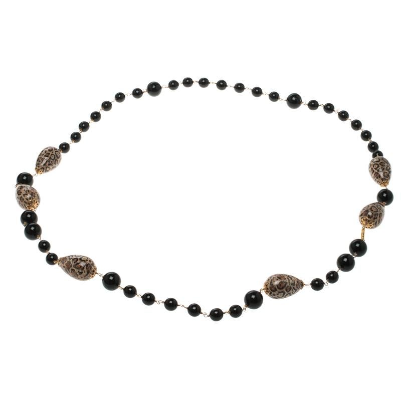 The Dolce and Gabbana black bead brown motif long necklace is a celebration if fashion at its most quirky and glamorous. Step out of your comfort zone of the same old jewellery and don this necklace to glam up any high neck monochrome dress.