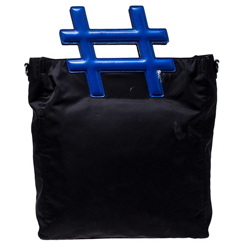 Flaunt this Hashtag tote from Dolce and Gabbana that is impeccably crafted for you. The black and blue piece is made of nylon and leather. It features a shoulder strap and a spacious interior that houses a zip pocket.

Includes: The Luxury Closet