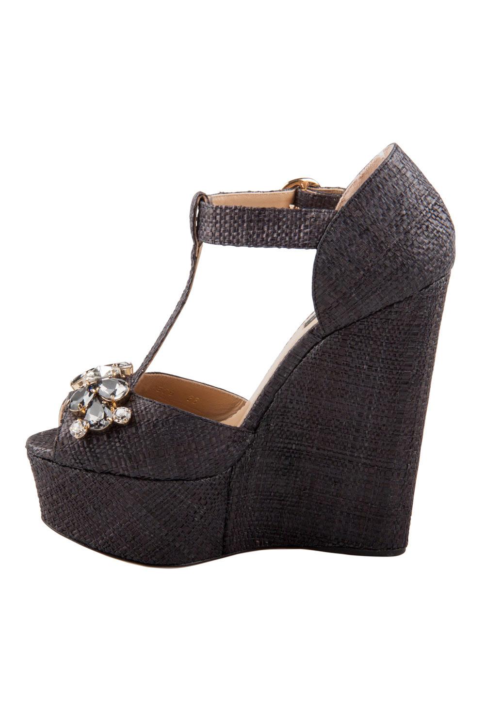 A classic combination of style and ease, these Dolce & Gabbana wedges are a pair every modern-day wardrobe should have. Set on comfortable wedge heels, this raffia pair features crystal embellishments on the uppers and ankle strap