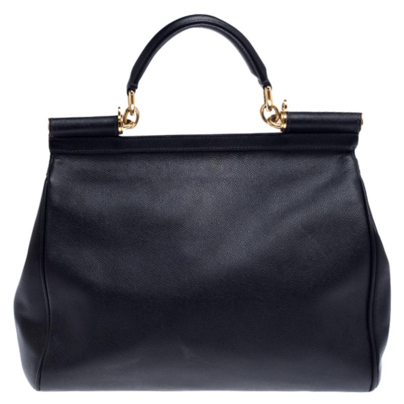 This gorgeous black Miss Sicily top handle bag from Dolce & Gabbana is coveted by women around the world. It has a well-structured design and a flap that opens to a compartment with fabric lining and enough space to fit your essentials. The bag