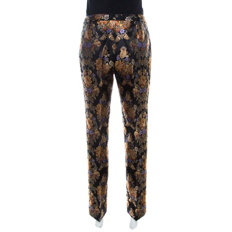 Cut from quality fabrics with jacquard effect, these Dolce and Gabbana trousers are a testament to the label's love for fine artistry and its Italian spirit. Floral detail adorned these black trousers that are ideal for a crisp evening look. They
