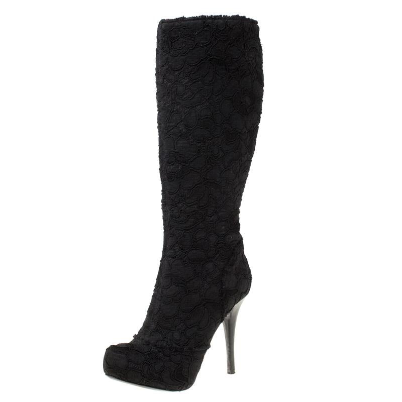 Dolce & Gabbana brings you this fabulous pair of knee length boots that will give you confidence and loads of style. They've been crafted from floral lace and tweed in a classy black shade and styled with platforms, 11.5 cm heels and back