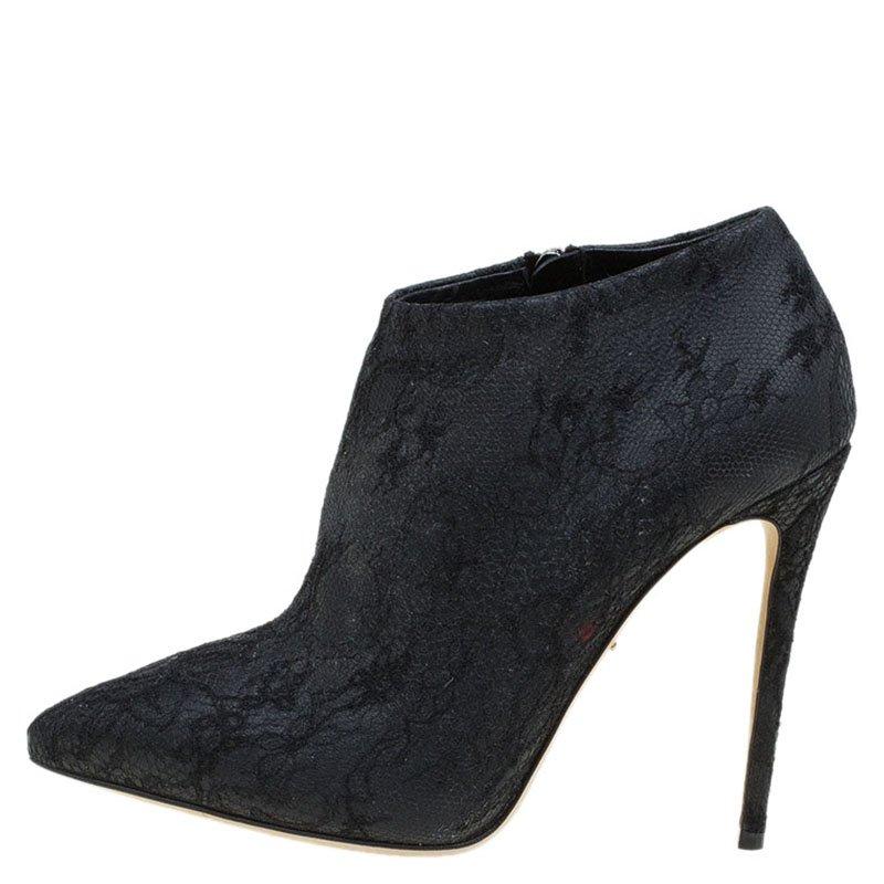 This gorgeous pair of boots from Dolce and Gabbana have a delicate lace pattern all over it. The pointed toe ankle length boots come with a high stiletto heel and zip fastening on the side. The lace pattern covers the heel as well. Step out in style