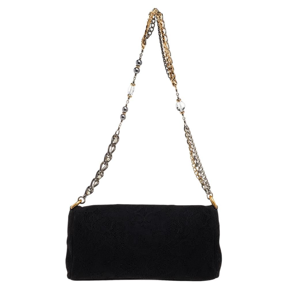 This chic handbag from the house of Dolce & Gabbana is a perfect fusion of style and elegance. This fascinating bag in black is brilliant to be accessorized with all kinds of dresses.

Includes: Original Dustbag