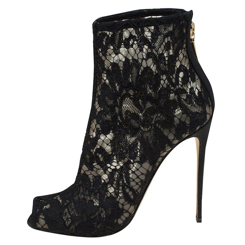 High on grace, these peep toe ankle boots from Dolce & Gabbana make for elevated street-style. With lace uppers and steep stiletto heels, they pair easily with jeans or skirts. Gold-tone zip detailing at the counters keep your feet