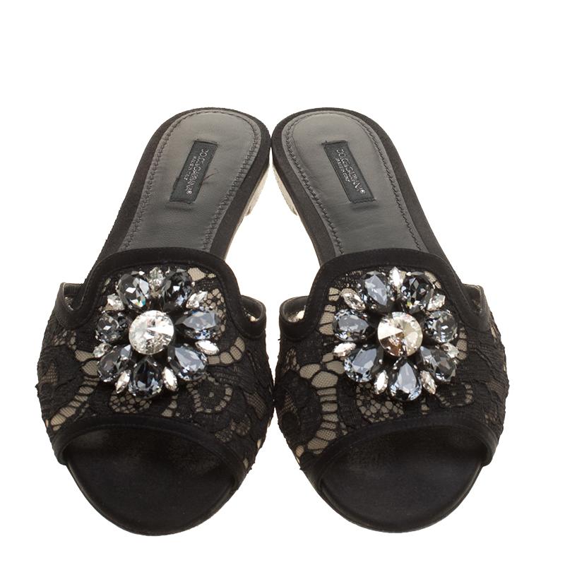 These Sofia slides from the house of Dolce and Gabbana features a lace and mesh frontal strap and detailed with crystal embellishment on it. This Italian made beauty features a leather sole. Easy to slip on and off, these slides are perfect for