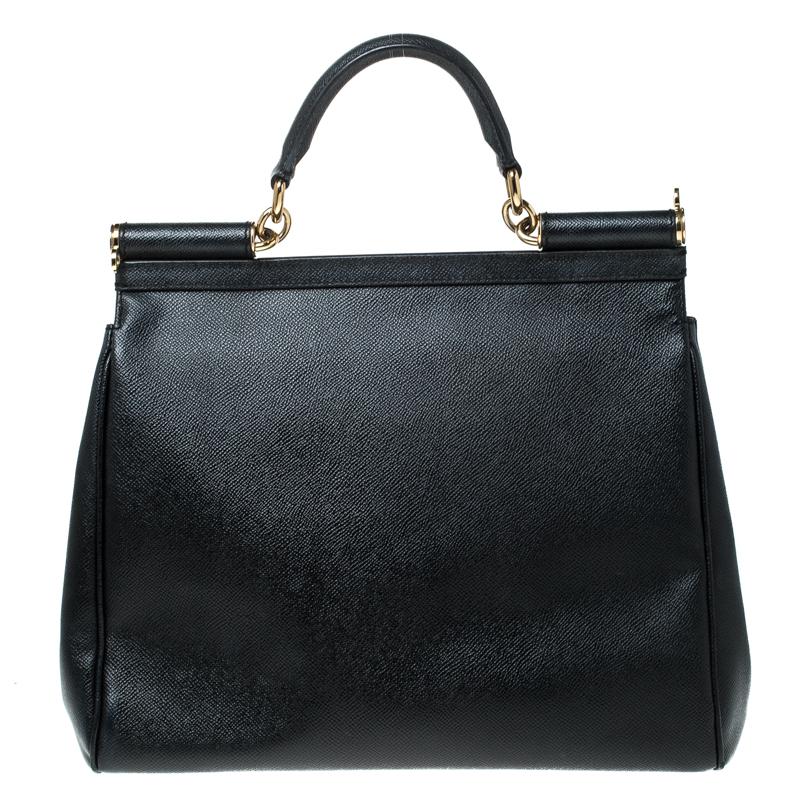 This gorgeous black Miss Sicily satchel from Dolce & Gabbana is a handbag coveted by women around the world. It has a well-structured design and a flap that opens to a compartment with fabric lining and enough space to fit your essentials. The bag