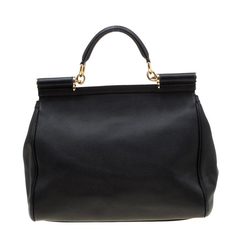 This gorgeous black Miss Sicily tote from Dolce & Gabbana is a leather bag coveted by women around the world. It has a well-structured design and a flap that opens to a compartment with fabric lining and enough space to fit your essentials. It comes