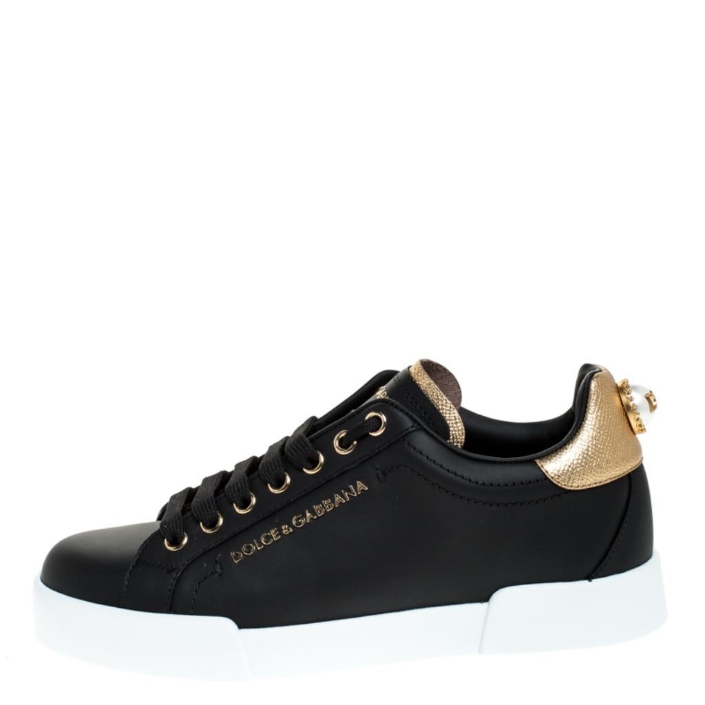 Dolce&Gabbana's Portofino sneakers are designed in a low top silhouette with pretty details that make them absolutely desirable. Black in color, they are crafted from leather featuring gold trims, brand details on the quarters and pearl