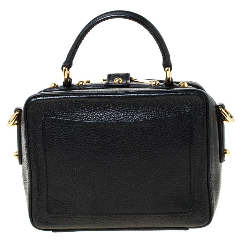 If you like to keep it minimal yet impressive, go for this Dolce and Gabbana handbag. Crafted from black leather, it is enhanced with gold-tone hardware. The bag features a top handle and a delicate floral embellishment on the lock fastening. The