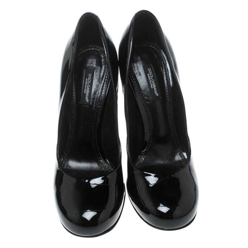 These black pumps from Dolce and Gabbana look very chic, classy and stylish. They are crafted from patent leather and feature round toes, comfortable leather lined insoles and 10.5 cm block heels. Pair them with knee-length dresses or formal
