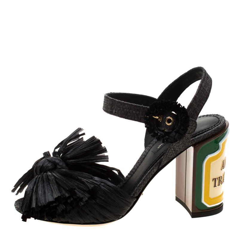 These black Keira sandals from Dolce and Gabbana are contemporary, edgy and very modern! They have been crafted from raffia and styled in an open toe silhouette. They flaunt a single vamp strap detailed with bows and buckled ankle straps. They come