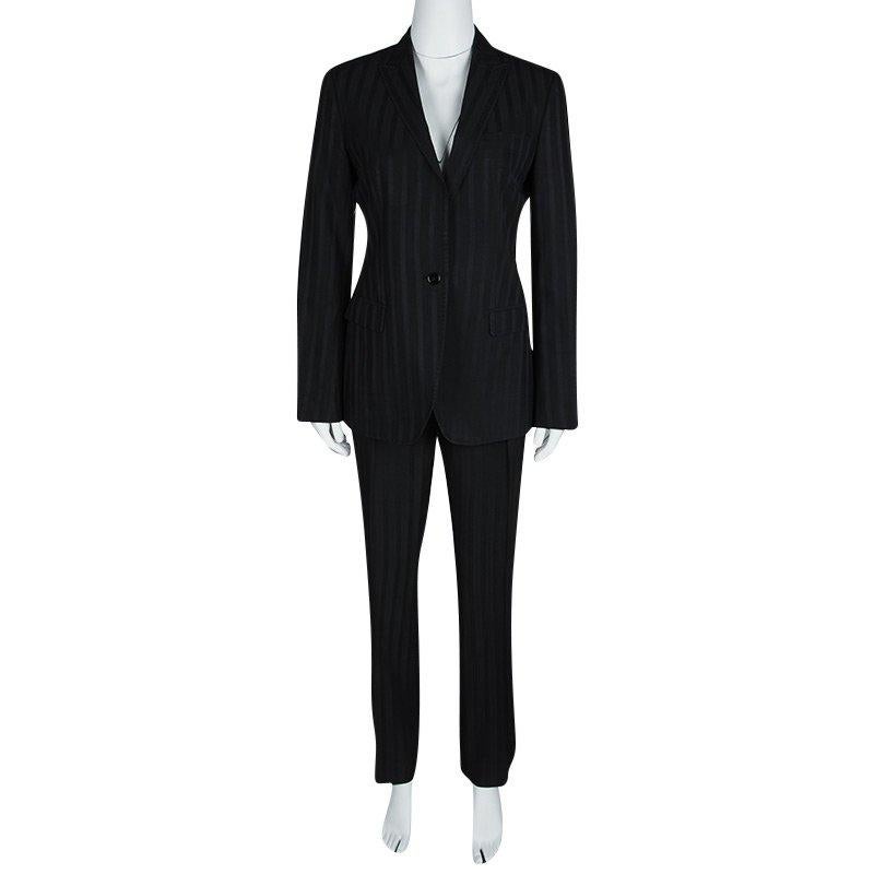 Ace the power dressing game with this pantsuit from Dolce and Gabbana. Tailored from a wool blend, the suit flaunts a classy black shade and stripes all over. The blazer comes with front buttons and notched lapels, while the pants come with front