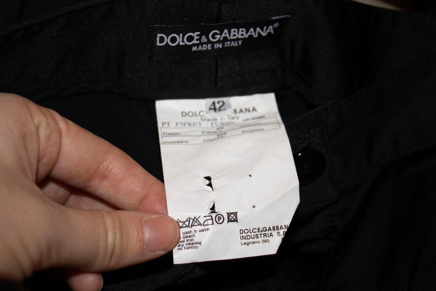 A chic pair of pants by Dolce and Gabbana. These polyester and spandex pants look like satin and have great tailoring, with belt hoops and slope pockets on the front. Size 42 , Italian. 
Measurements: waist 32'' , inside leg 35'' plus 2 '' hem.