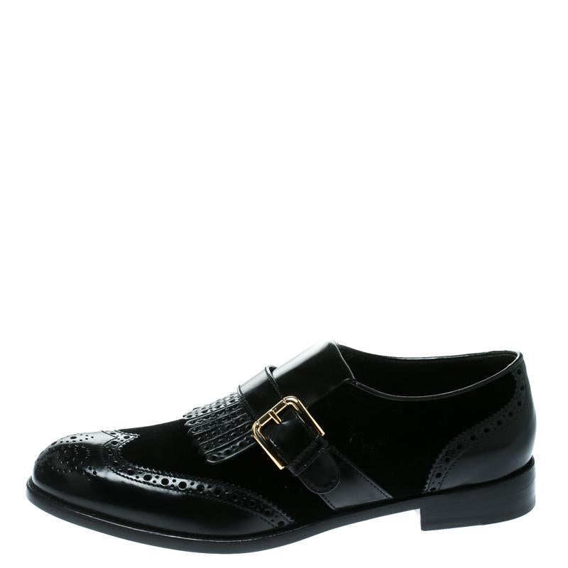 These fabulous loafers from Dolce and Gabbana have been missing from your wardrobe all this while and now wait for you to make them yours! These black loafers are crafted from velvet and brogue leather and feature round toes. They have been styled