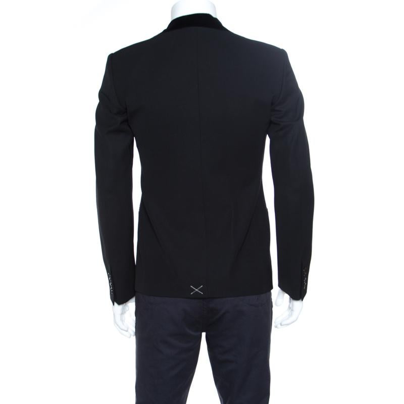 Give your formal look a stunning fashion update with this blazer from Dolce and Gabbana. Designed fabulously, it features a classic black hue all over the wool blend body. The blazer offers a crisp fitting and is equipped with twin button closure,