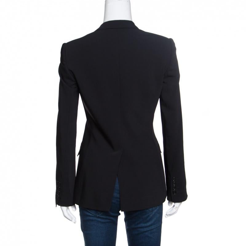 This tailored blazer from Dolce and Gabbana is sure to make you look sharp and very stylish! The black blazer is made of a wool blend and features a well-defined silhouette. It flaunts notched lapels, a chest pocket, front button fastenings, twin