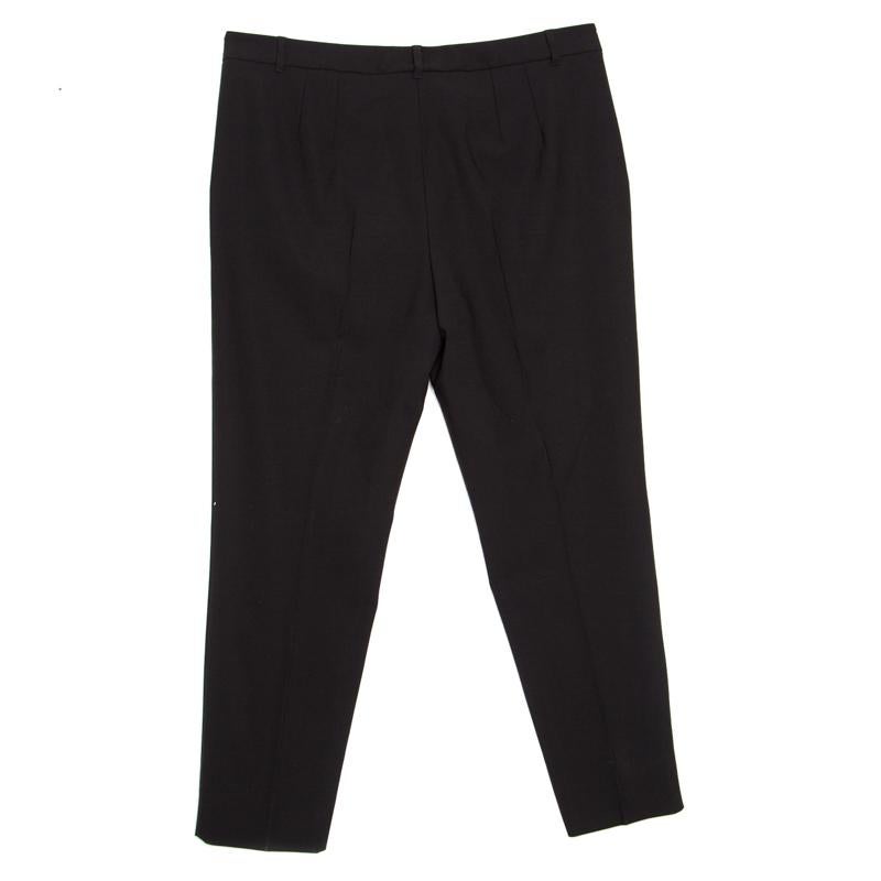These tailored trousers from Dolce and Gabbana deserve all your attention. The black pair is made of a wool blend and features a simple structured silhouette. The trousers come equipped with a front button fastening and belt loop closures. They can